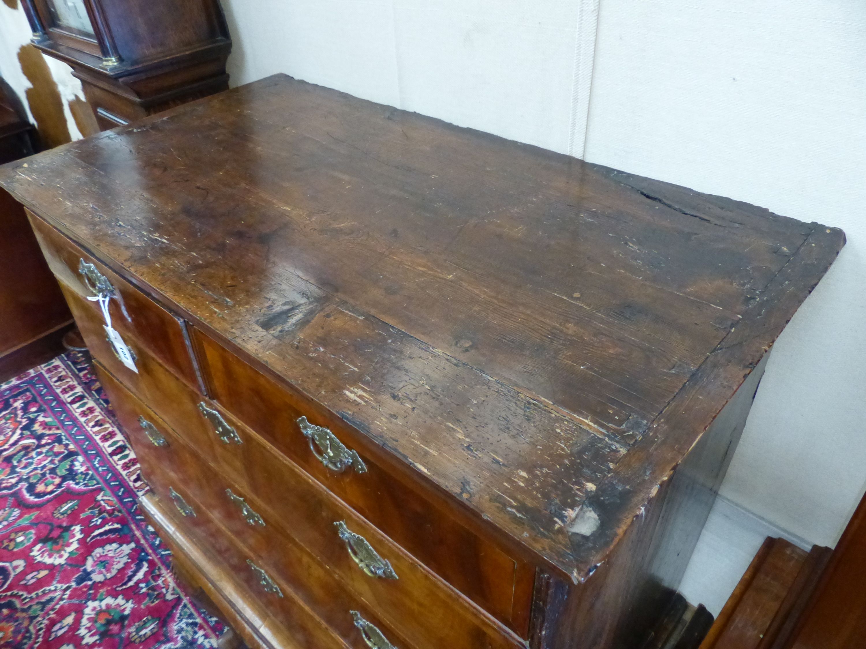 An early 18th century walnut and pine sided chest on stand, width 101cm, depth 58cm, height 138cm